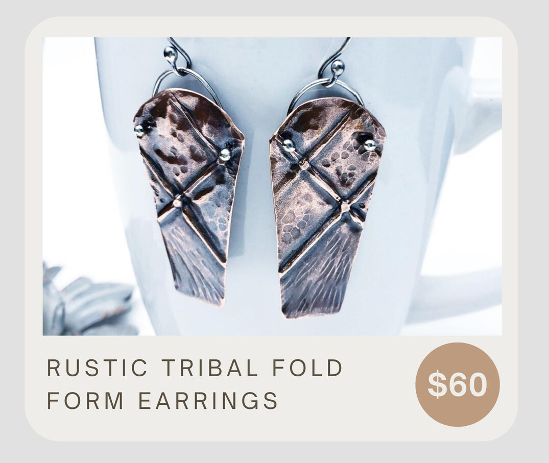 These artisan mixed metal copper and sterling silver earrings are handmade with fold forming, sterling silver heat rivet accents, and hammered textures. These handmade funky earrings dangle about 2 3/8" inches by 7/8" wide.