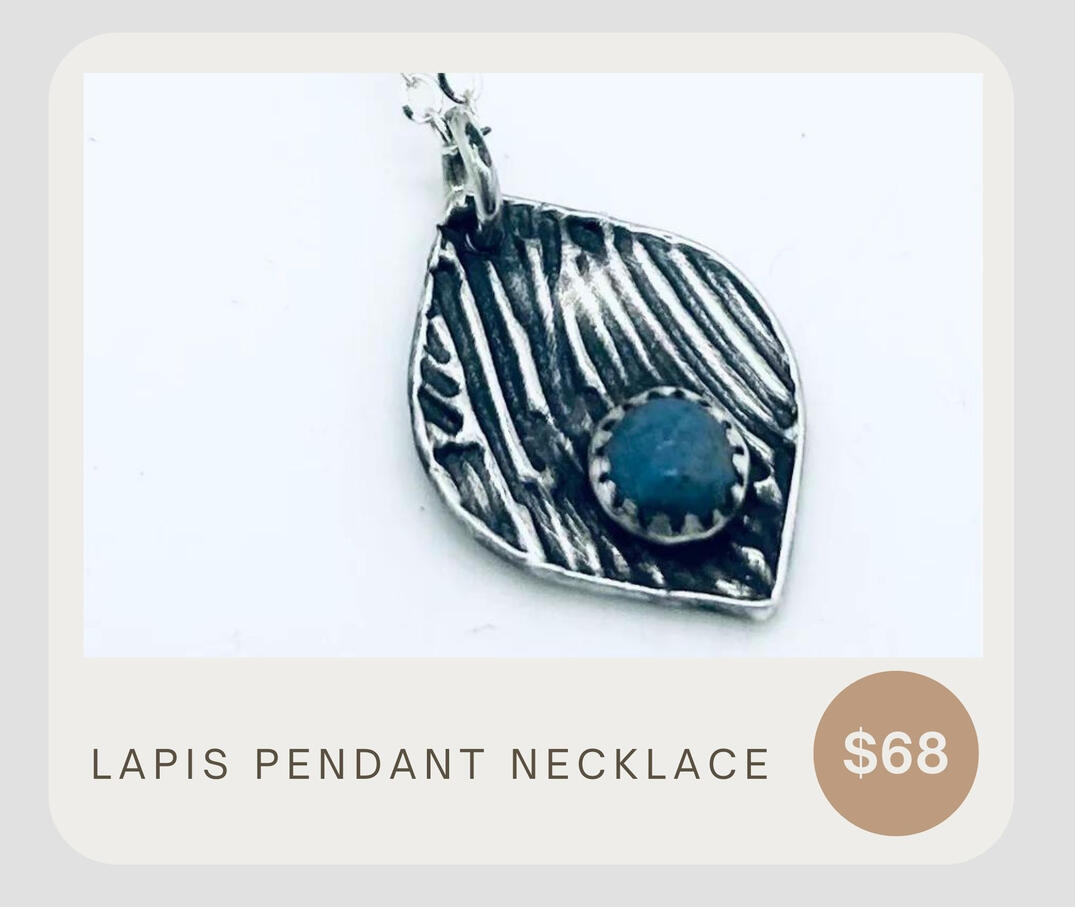 This sterling silver necklace boasts a fine silver pendant and Lapis gemstone adorned with a rustic patina design. 18" chain.